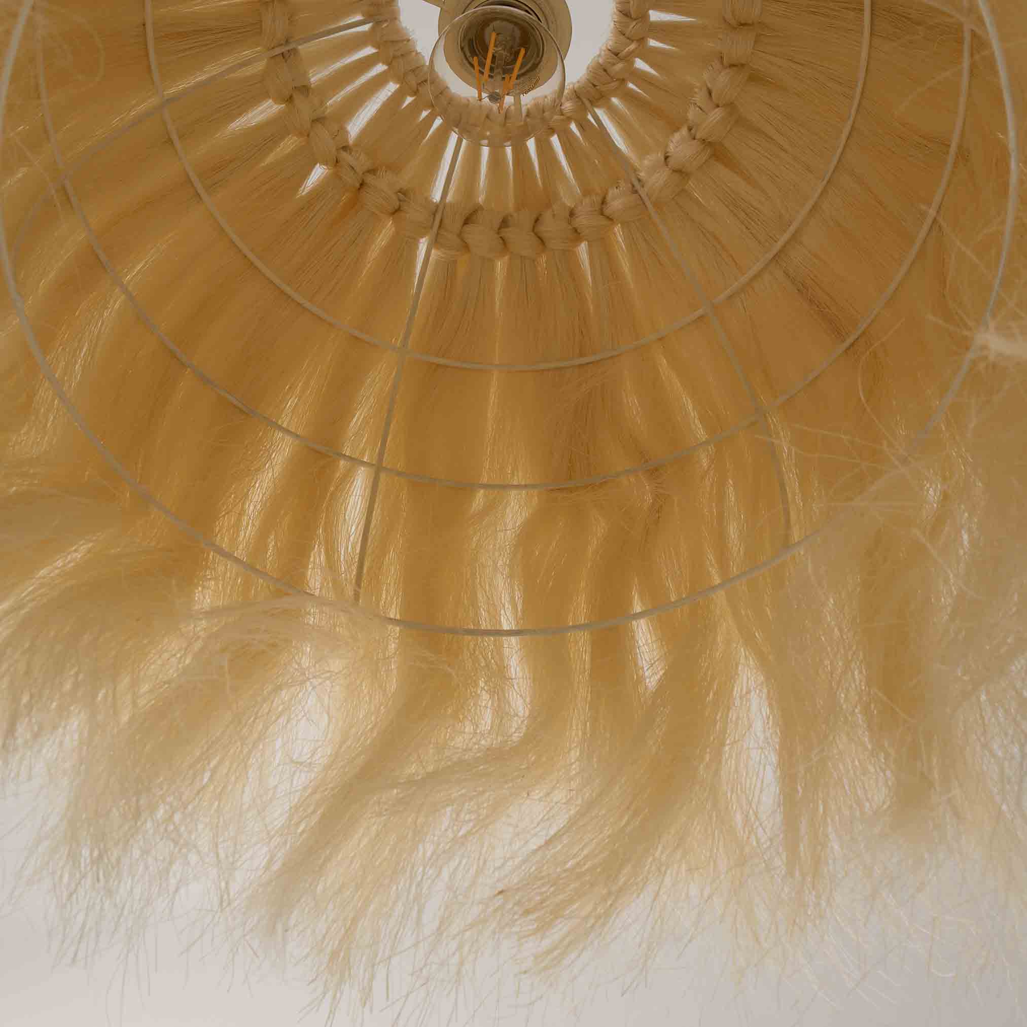 Underside of a boho pendant lamp shade made from natural sisal fibers