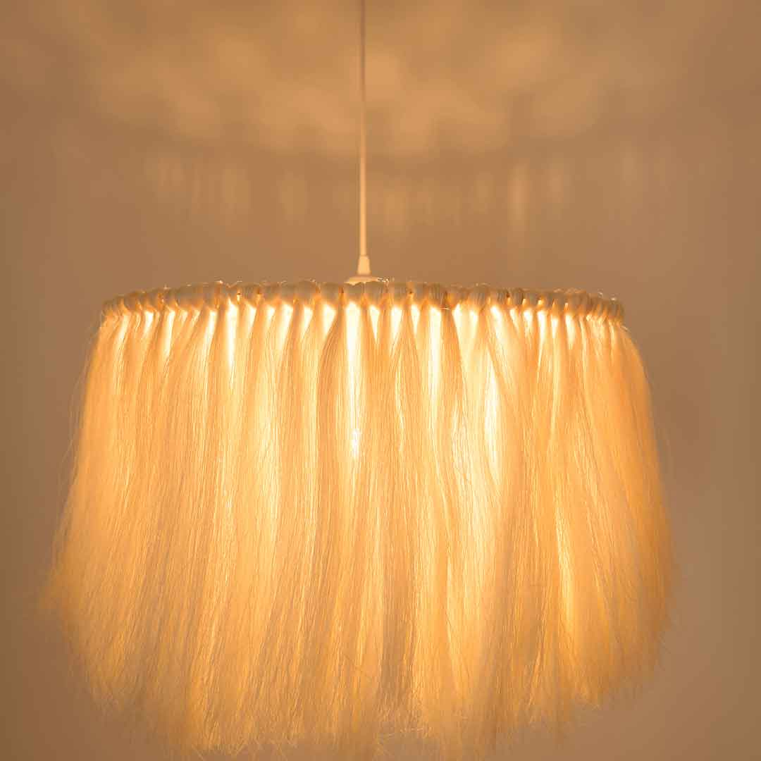 The soft light lamp has a custom metal frame that casts a floral pattern of light and shadow on the ceiling.