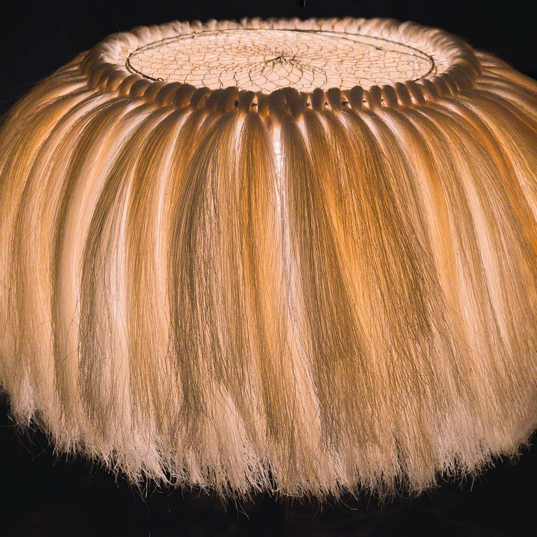 A close-up photo of a lamp shade made of sisal fibers