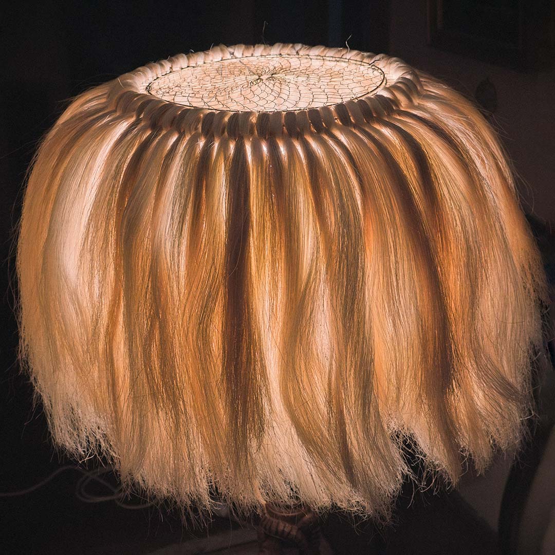 A close-up of a handcrafted lamp shade made of sisal fibers