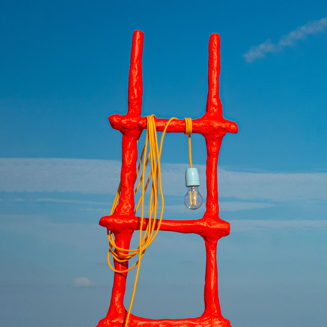 Red ladder lamp with yellow cord